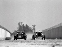 Lexihaunted on a white hot rod racing a chick from another race club down a dry cement drainage way alongside an LA freeway.